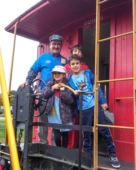 kids on the caboose with grandpa